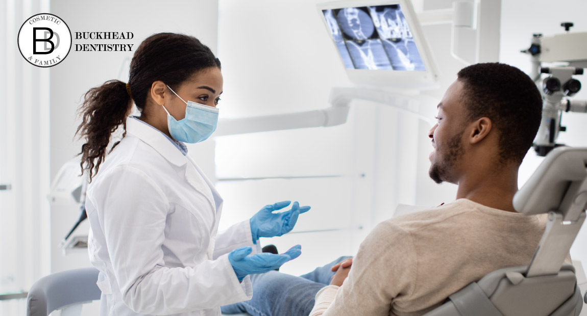 An endodontist explains to their patient the details of a root canal procedure.